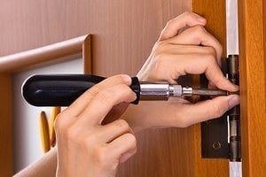 screwing hinge on a door